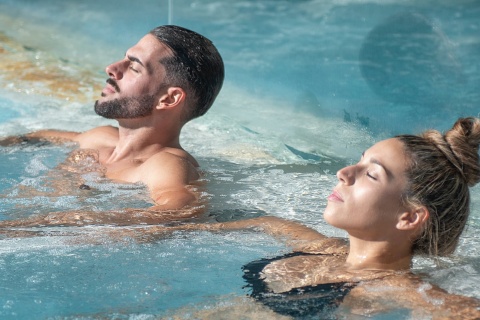 Couple relaxing in a jacuzzi in the Balneario de Las Caldas spa, Cantabria, Spain