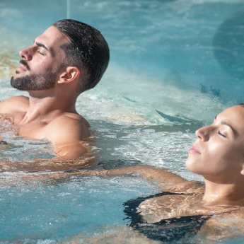 Couple relaxing in a jacuzzi in the Balneario de Las Caldas spa, Cantabria, Spain