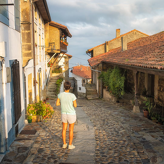 Tourist strolling through Lastres, Asturias