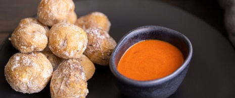 Papas con mojo picón (wrinkly potatoes with a spicy red mojo sauce)